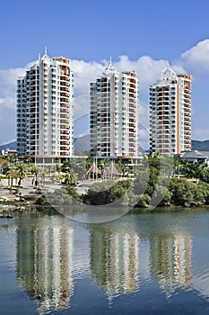 Apartment buildings mirrored in a canal, Sanya, China